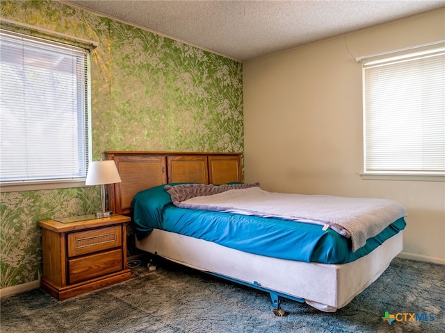 carpeted bedroom with a textured ceiling