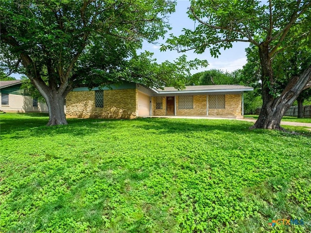 1107 Elm Ln, Marble Falls, TX 78654 - view of front facade featuring stone siding, a garage, and a front yard
