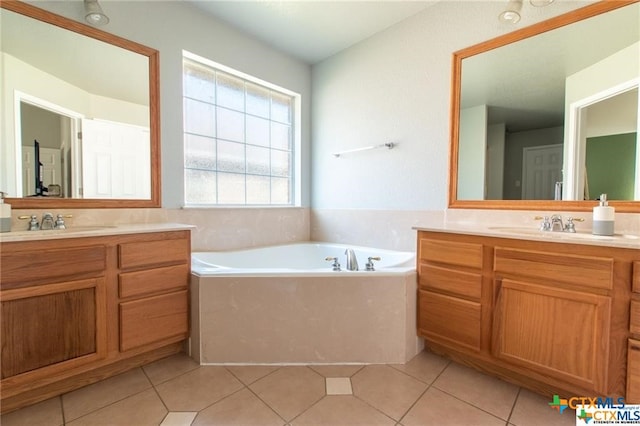 bathroom featuring vanity, tile patterned floors, and a bathing tub