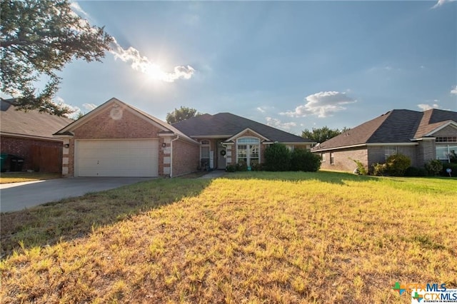 single story home featuring a garage and a front lawn