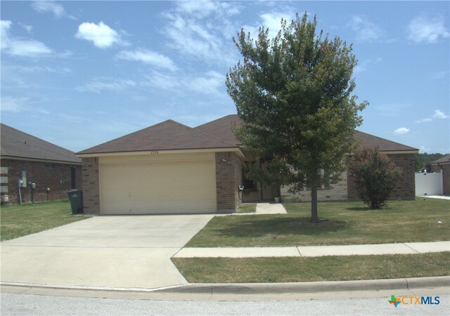 2726 Settlement Rd, Copperas Cove, TX 76522 - view of front of home featuring brick siding, concrete driveway, a garage, and a front lawn