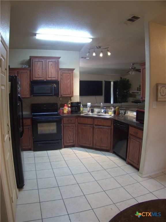 2726 Settlement Rd, Copperas Cove, TX 76522 - kitchen featuring black appliances, light tile patterned floors, dark countertops, and decorative backsplash
