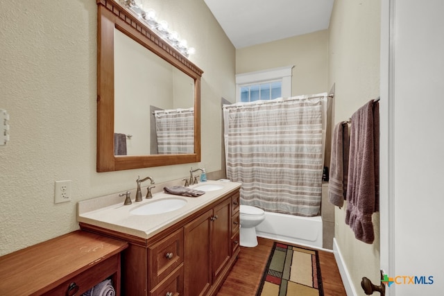 full bathroom with hardwood / wood-style floors, vanity, toilet, and shower / bath combination with curtain