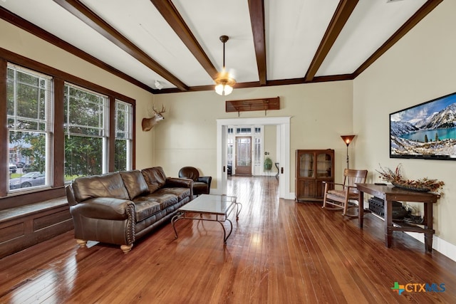 living room featuring ornamental molding, hardwood / wood-style floors, and beam ceiling