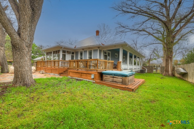 back of property featuring a yard and a deck