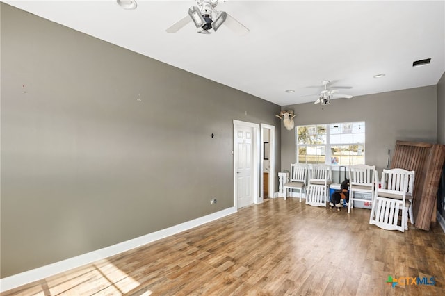 interior space with hardwood / wood-style floors and ceiling fan