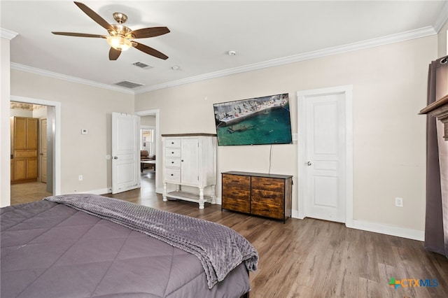 bedroom with ornamental molding, wood-type flooring, and ceiling fan