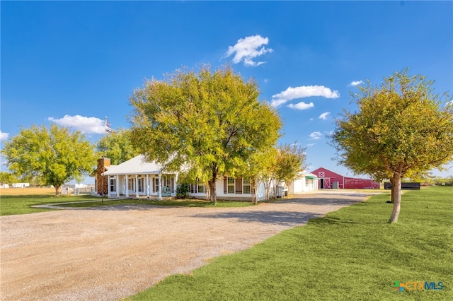 view of front of house with a porch and a front yard