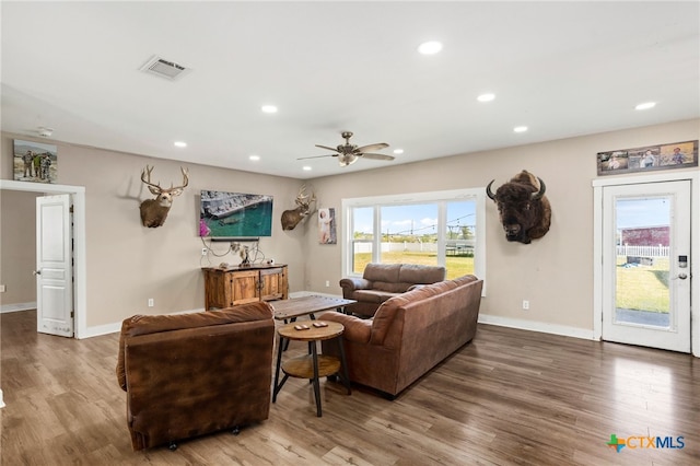 living room with hardwood / wood-style floors and ceiling fan