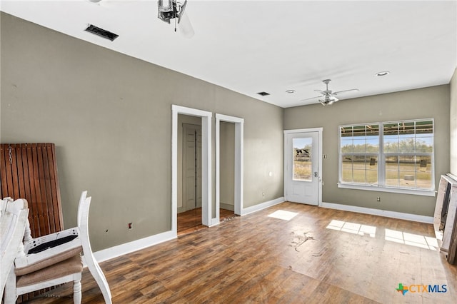 interior space featuring wood-type flooring and ceiling fan