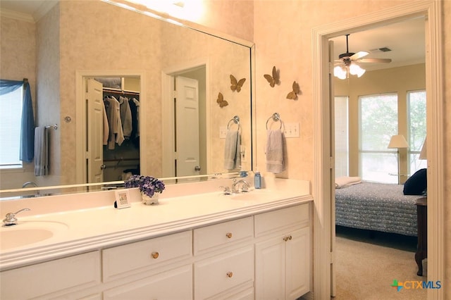 bathroom featuring ornamental molding, vanity, and ceiling fan