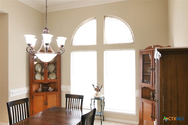 dining area featuring a notable chandelier and ornamental molding