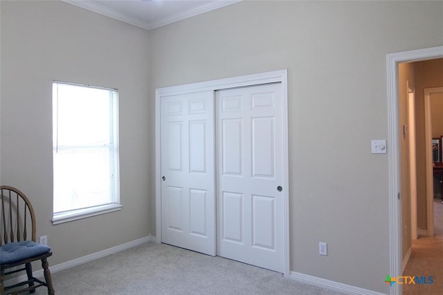 living area featuring ornamental molding and light carpet