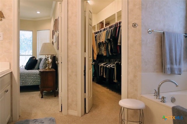 bathroom with vanity, a tub, and ornamental molding