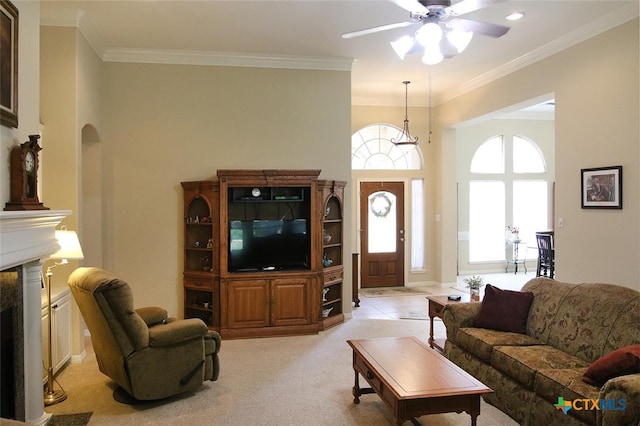 carpeted living room with ceiling fan and ornamental molding