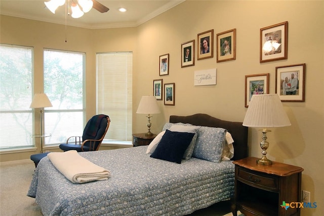 bedroom with ornamental molding, ceiling fan, and carpet floors