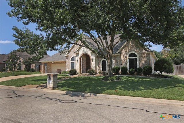 view of front of home featuring a garage and a front yard