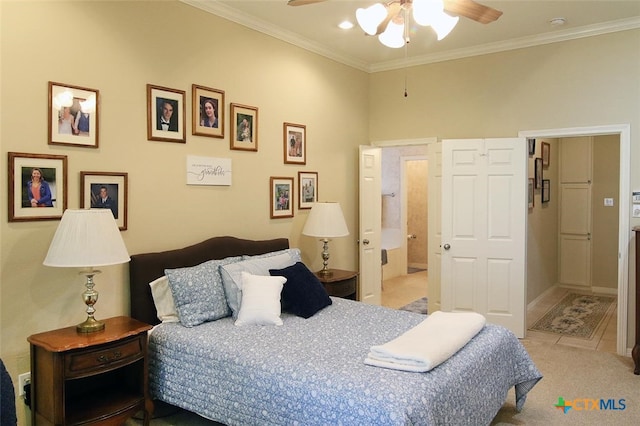 bedroom featuring ceiling fan, connected bathroom, light carpet, and ornamental molding