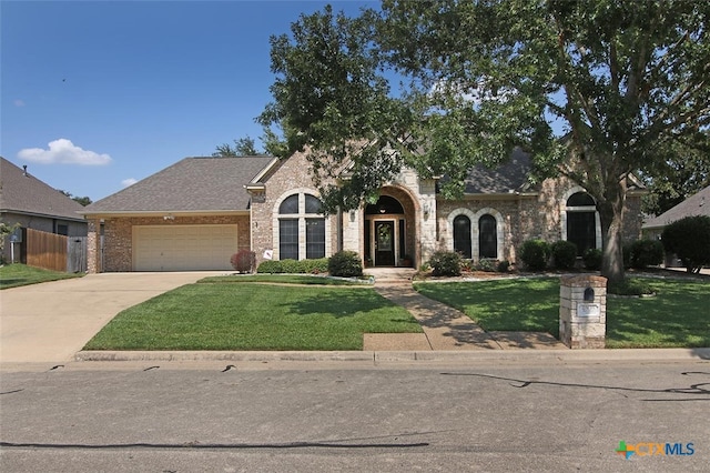 view of front of home with a garage and a front yard