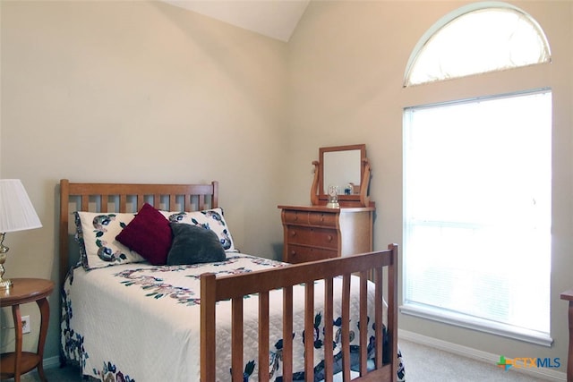 carpeted bedroom featuring lofted ceiling