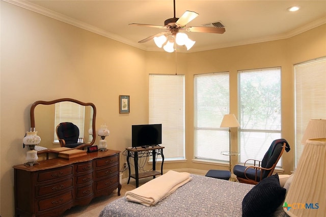 carpeted bedroom with ceiling fan and ornamental molding