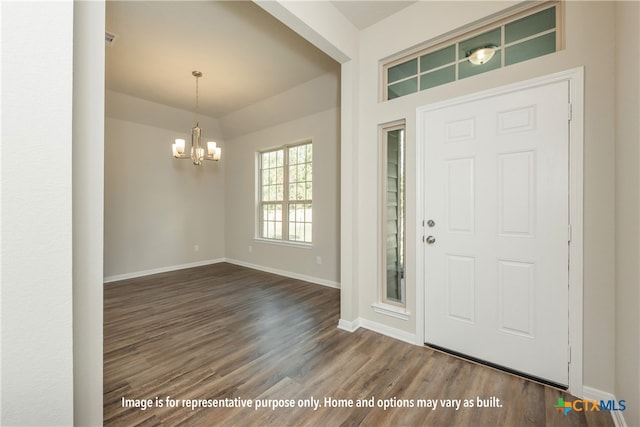 foyer featuring dark hardwood / wood-style floors and a notable chandelier