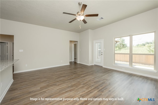 unfurnished living room with a textured ceiling, dark hardwood / wood-style flooring, and ceiling fan