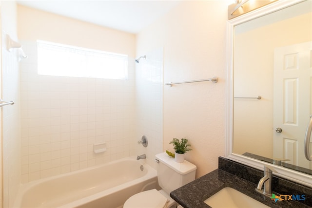 full bathroom featuring toilet, tiled shower / bath combo, and vanity