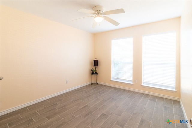 spare room with dark hardwood / wood-style flooring and ceiling fan