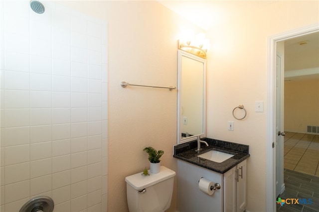 bathroom with tile patterned flooring, vanity, and toilet