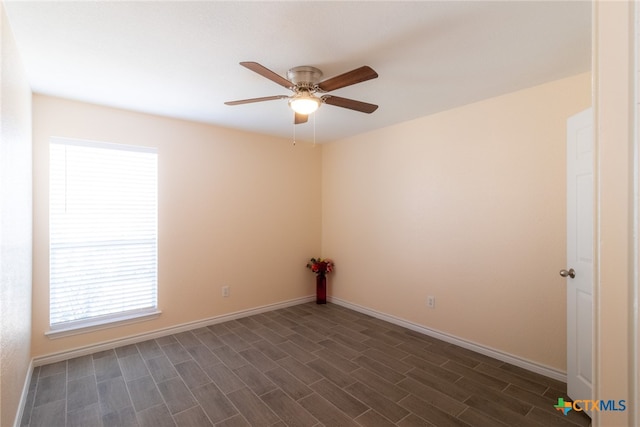 empty room featuring dark wood-type flooring, ceiling fan, and plenty of natural light