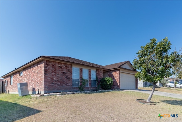 ranch-style home with a garage and a front lawn