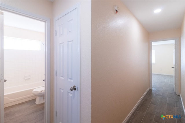 corridor featuring dark hardwood / wood-style flooring