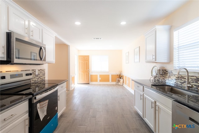 kitchen with white cabinetry, appliances with stainless steel finishes, sink, and plenty of natural light