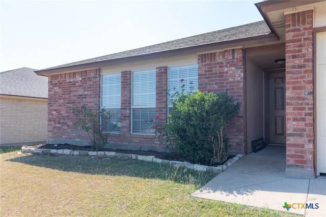 view of side of home with a yard