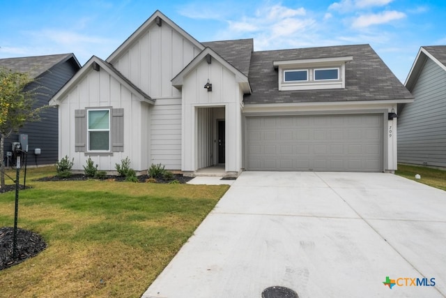 view of front of home featuring a garage and a front lawn