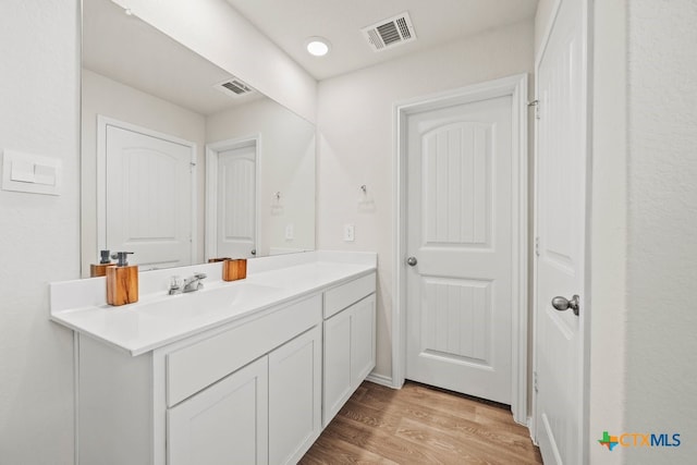 bathroom featuring vanity and hardwood / wood-style flooring