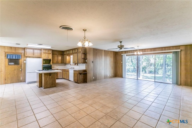 kitchen featuring open floor plan, visible vents, open shelves, and white appliances