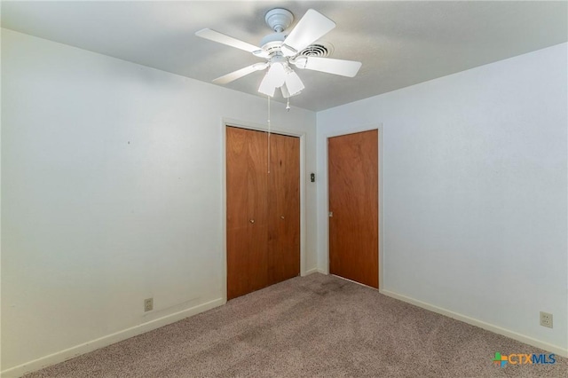 unfurnished bedroom featuring carpet flooring, baseboards, a closet, and ceiling fan