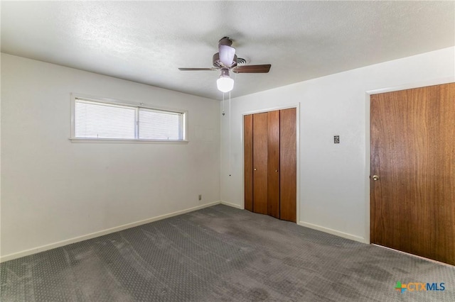 unfurnished bedroom featuring carpet floors, baseboards, a closet, and a textured ceiling