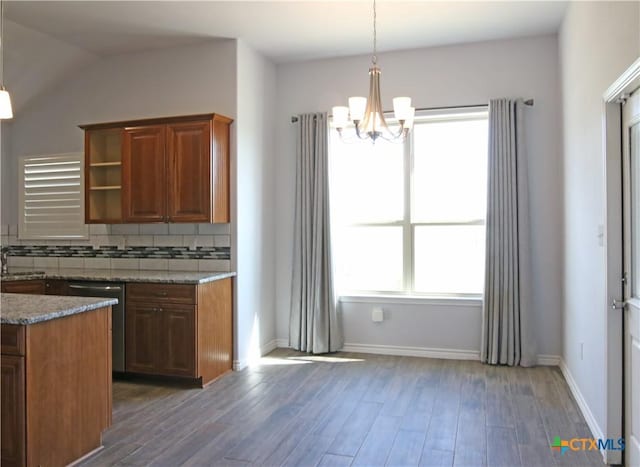 2734 Rock Rd, Troy, TX 76579 - kitchen with a chandelier, wood finished floors, backsplash, light stone counters, and stainless steel dishwasher