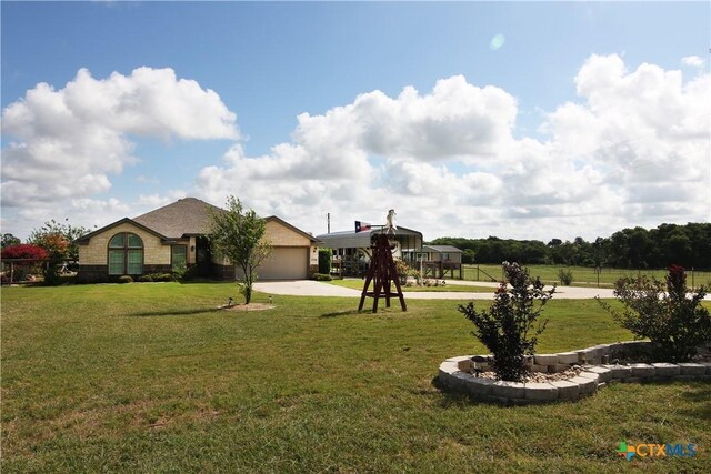 2734 Rock Rd, Troy, TX 76579 - view of green lawn with driveway and a garage