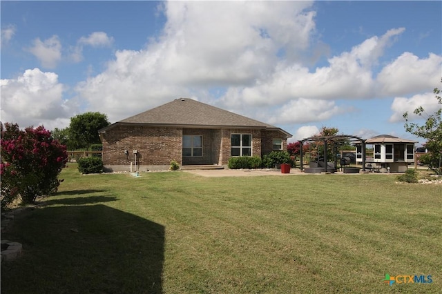 2734 Rock Rd, Troy, TX 76579 - back of property featuring a patio, a lawn, brick siding, and roof with shingles