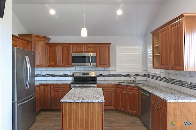 2734 Rock Rd, Troy, TX 76579 - kitchen with appliances with stainless steel finishes, lofted ceiling, wood finished floors, brown cabinetry, and backsplash