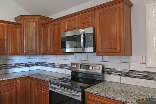 2734 Rock Rd, Troy, TX 76579 - kitchen with stainless steel appliances, brown cabinets, backsplash, and light stone counters