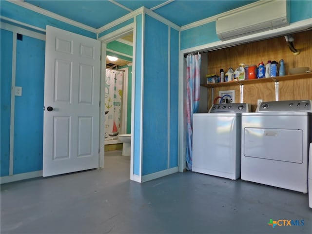 laundry room with an AC wall unit, washing machine and dryer, and ornamental molding