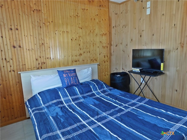 bedroom featuring wooden walls