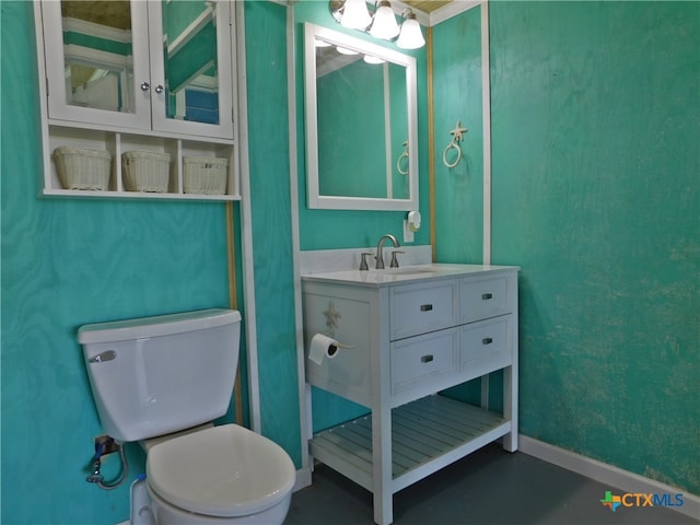 bathroom featuring toilet and vanity