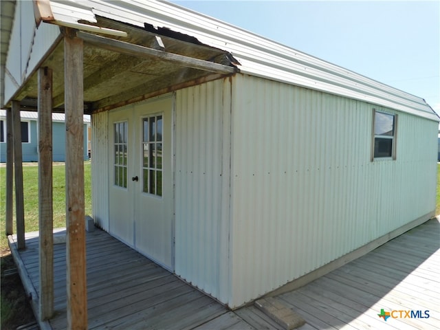 view of outbuilding featuring a lawn and french doors