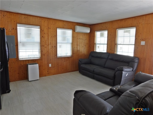 living room with plenty of natural light, wood walls, and an AC wall unit